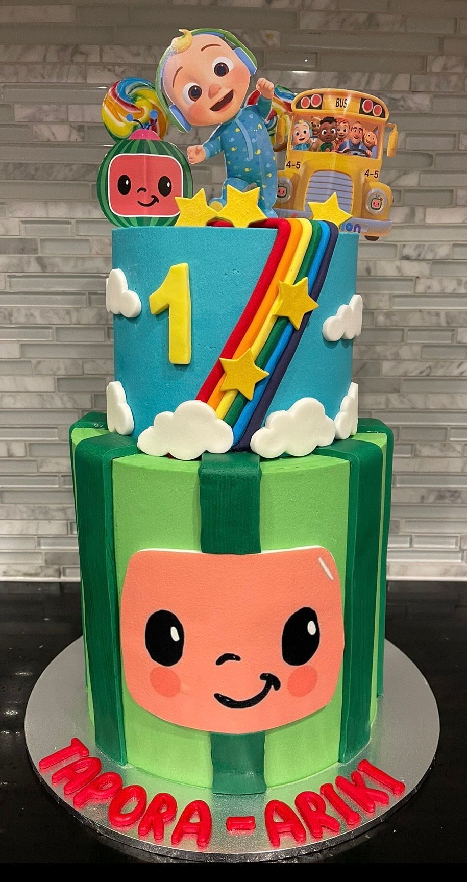 A cake with a baby on top of it is on a table.