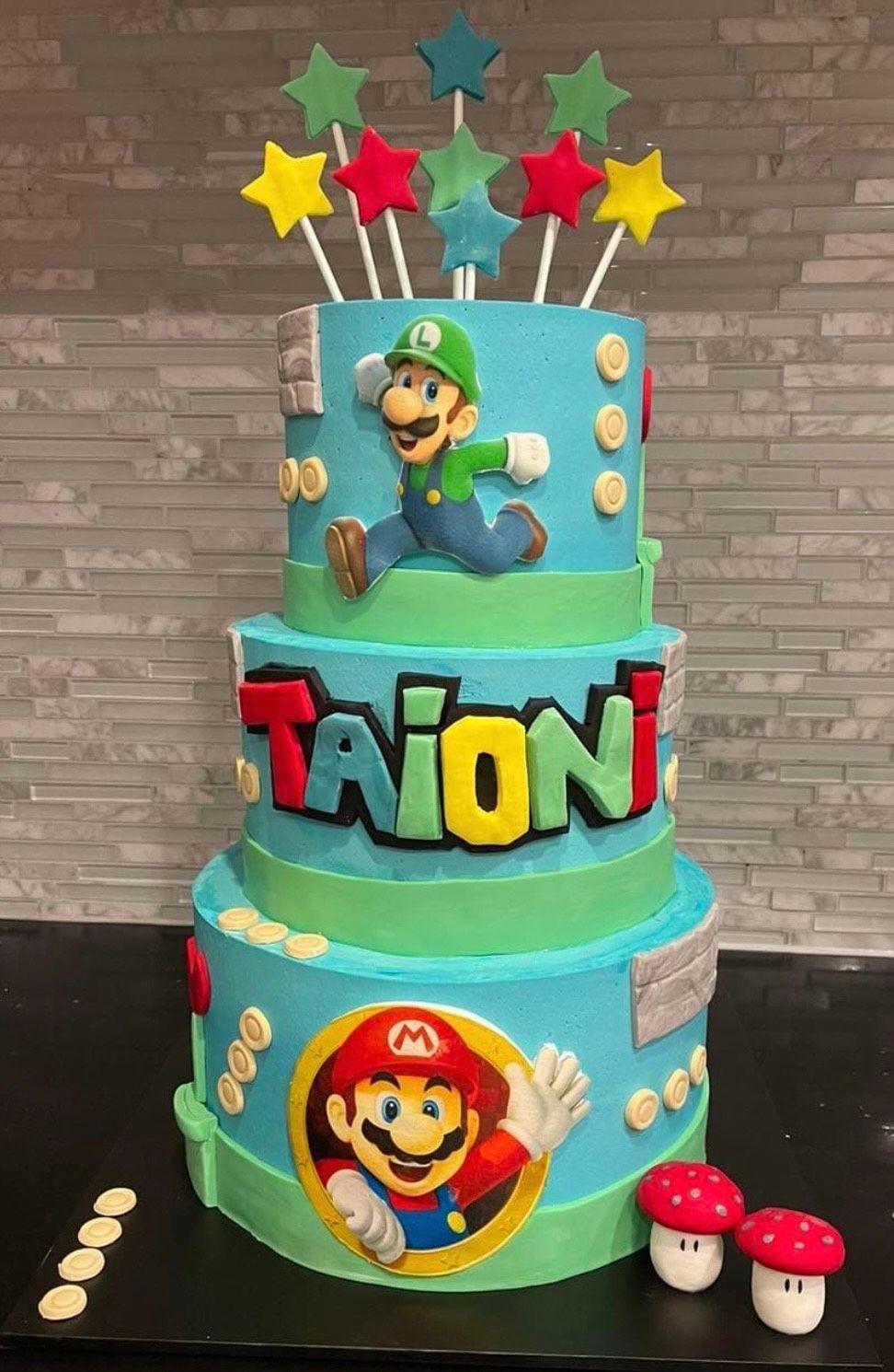 A birthday cake with mario and luigi on it is on a table.