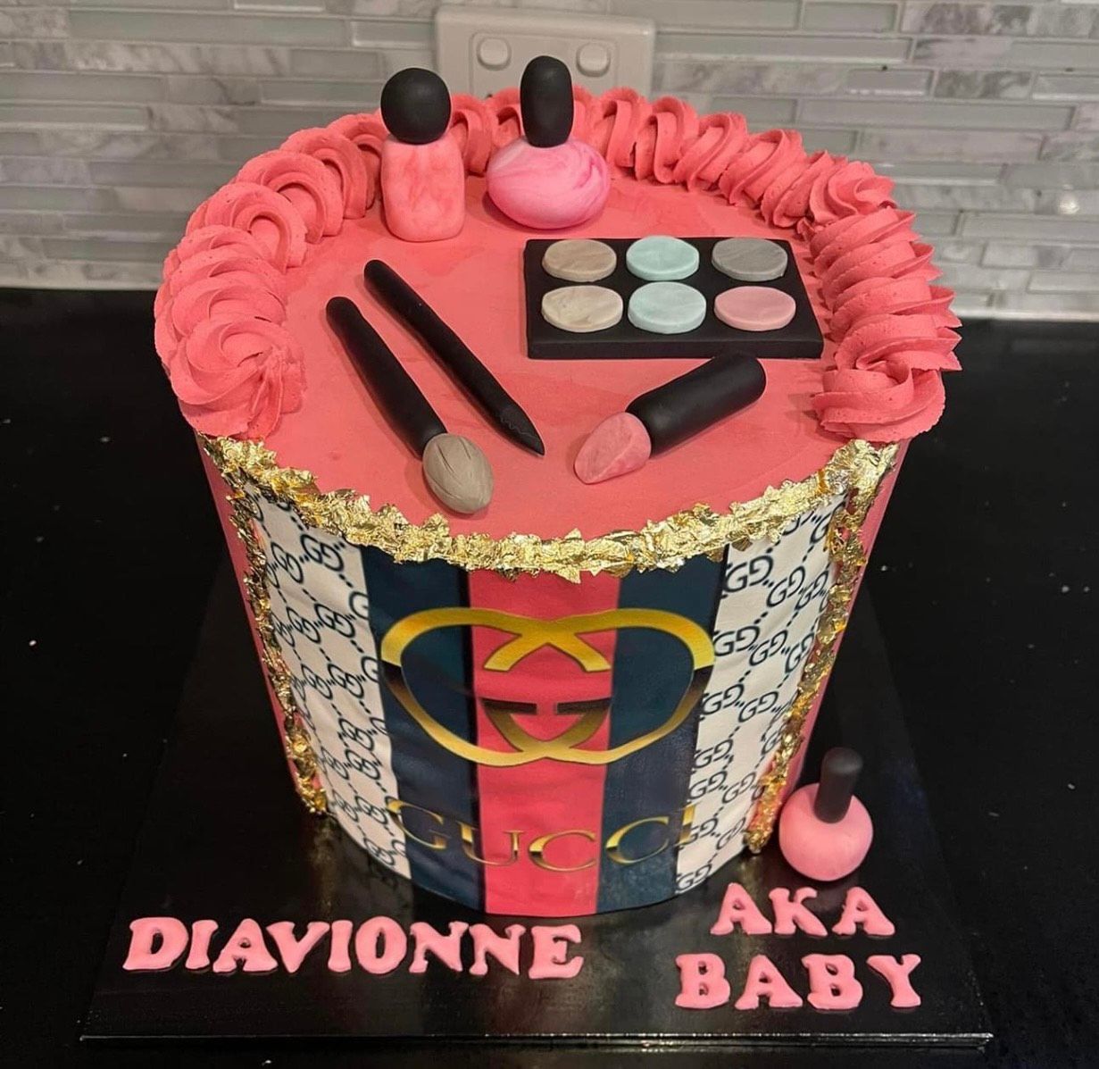 A pink cake with makeup and the name diavionne on it