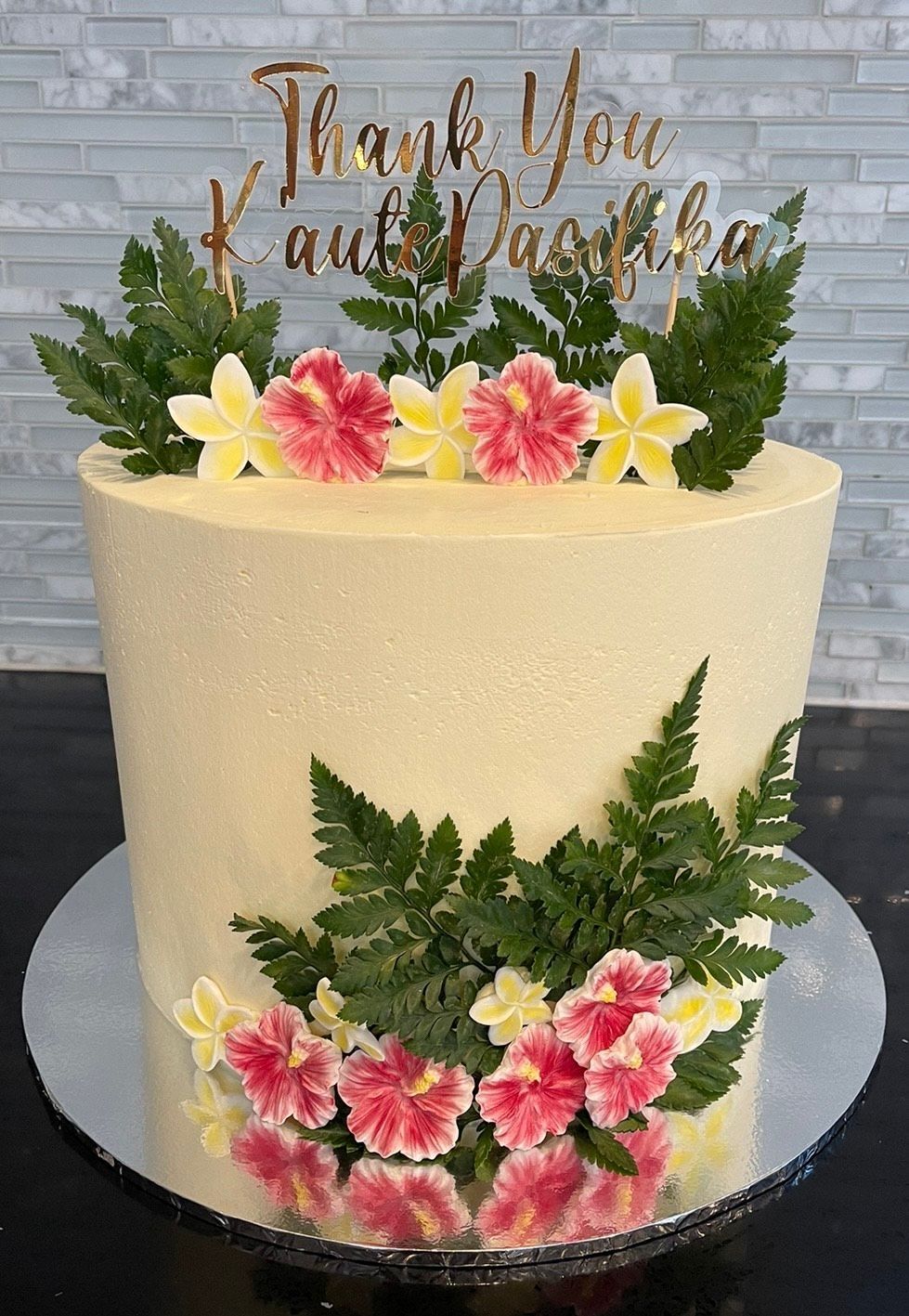 A cake with flowers and leaves on top of it.