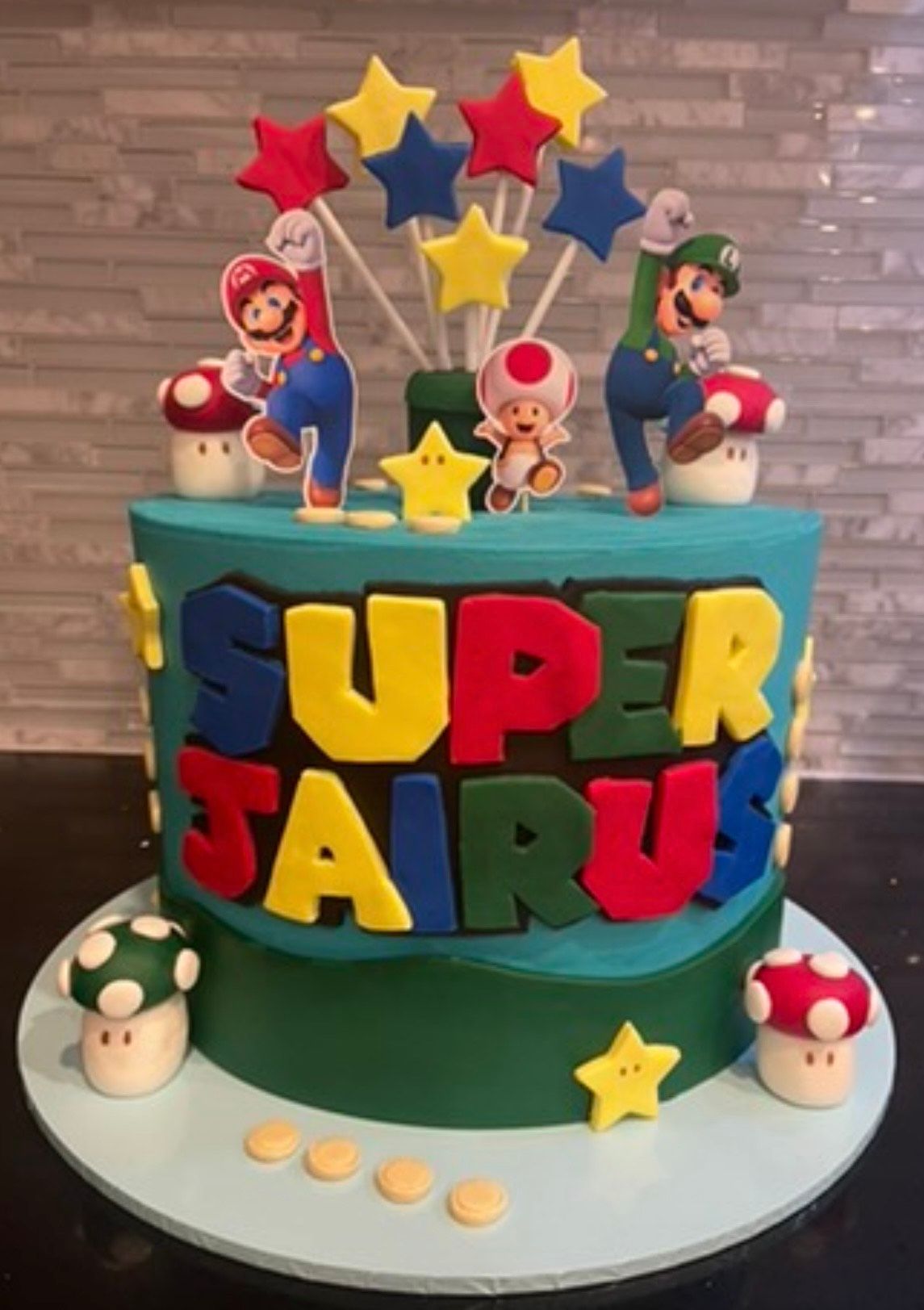 A super mario cake with mushrooms and stars on top