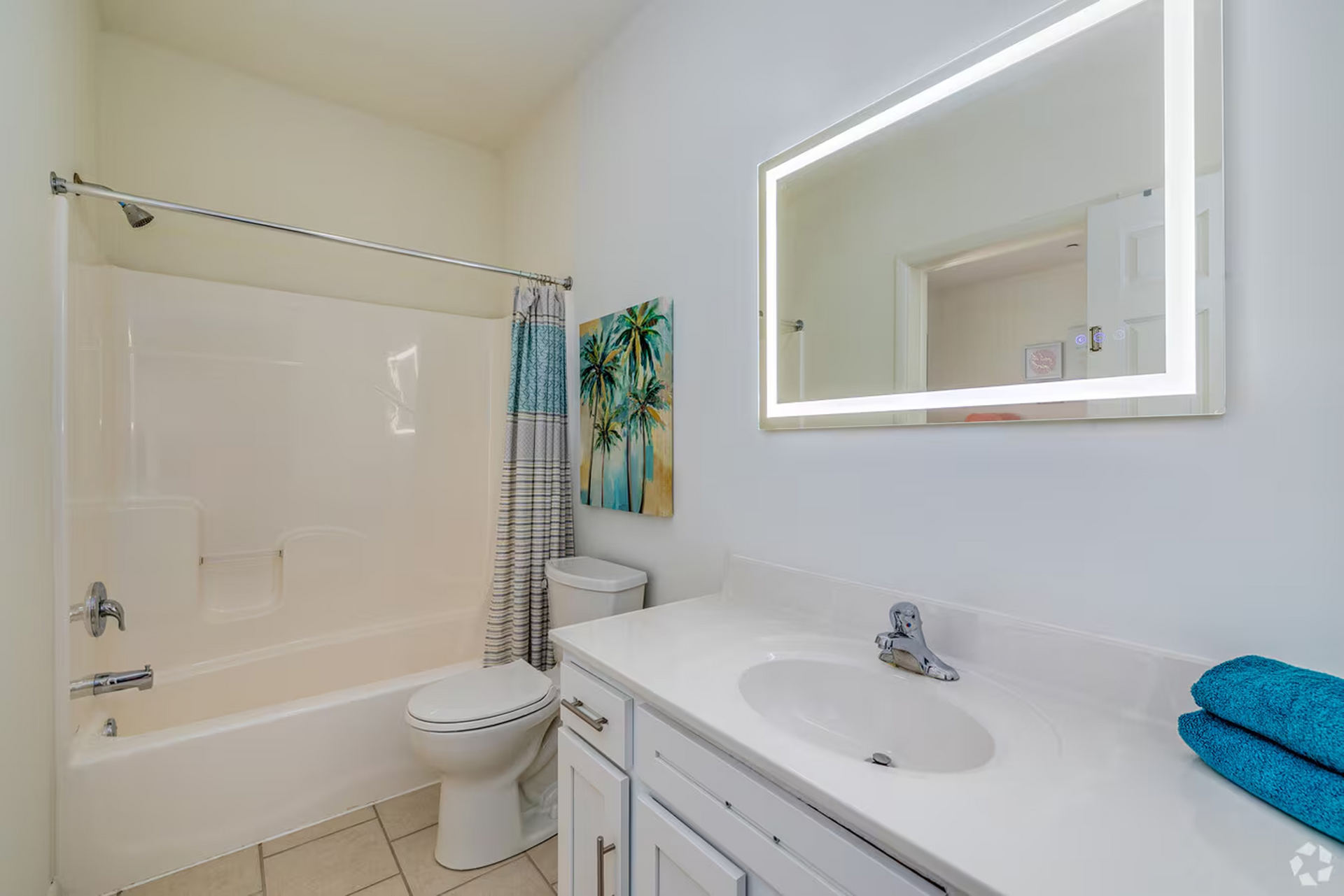 Modern bathroom with full shower and large mirror at Temple Crossing