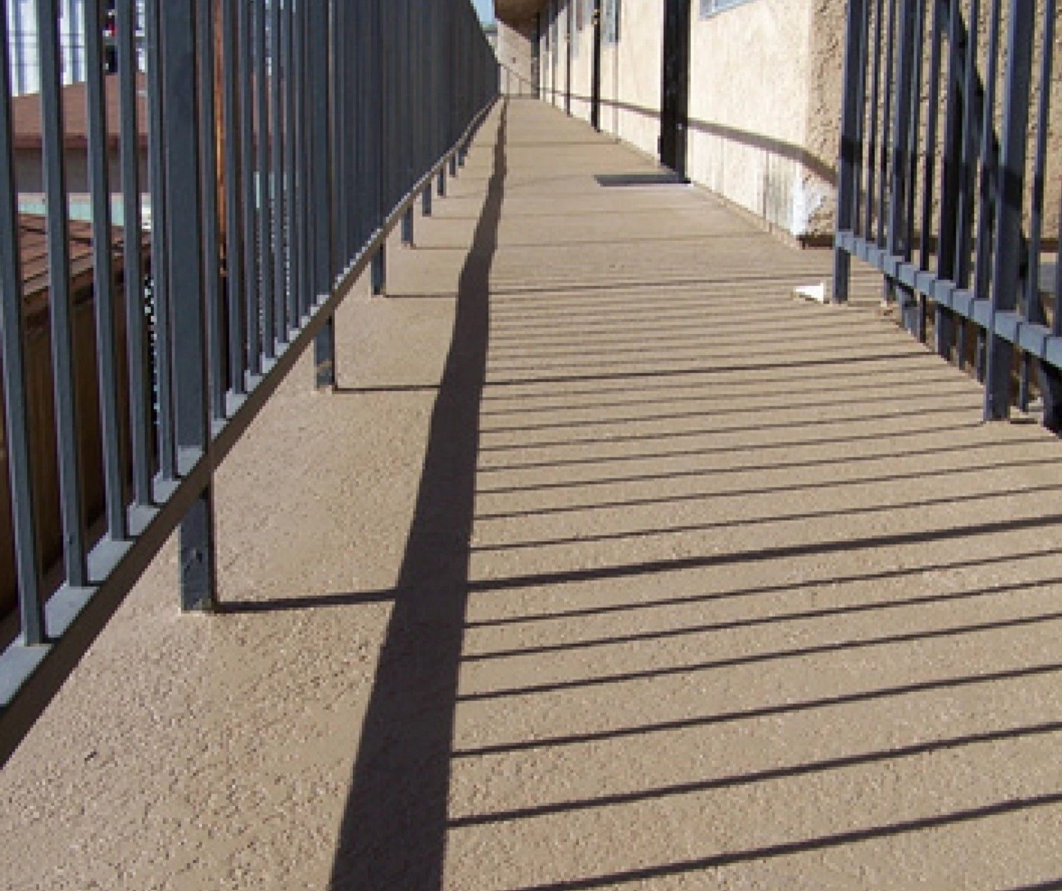 A walkway with a railing along the side of it