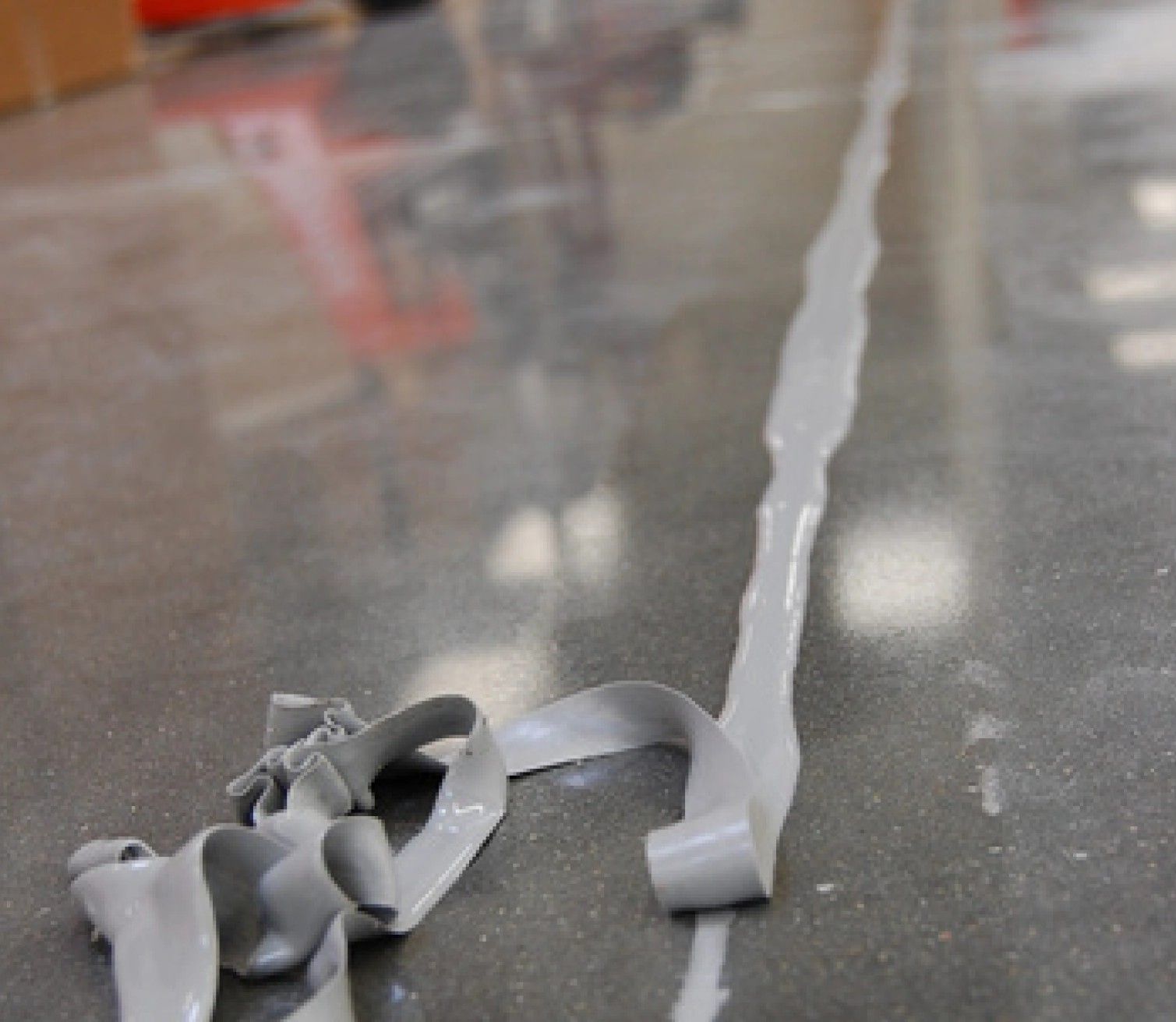 A roll of duct tape is laying on the floor.