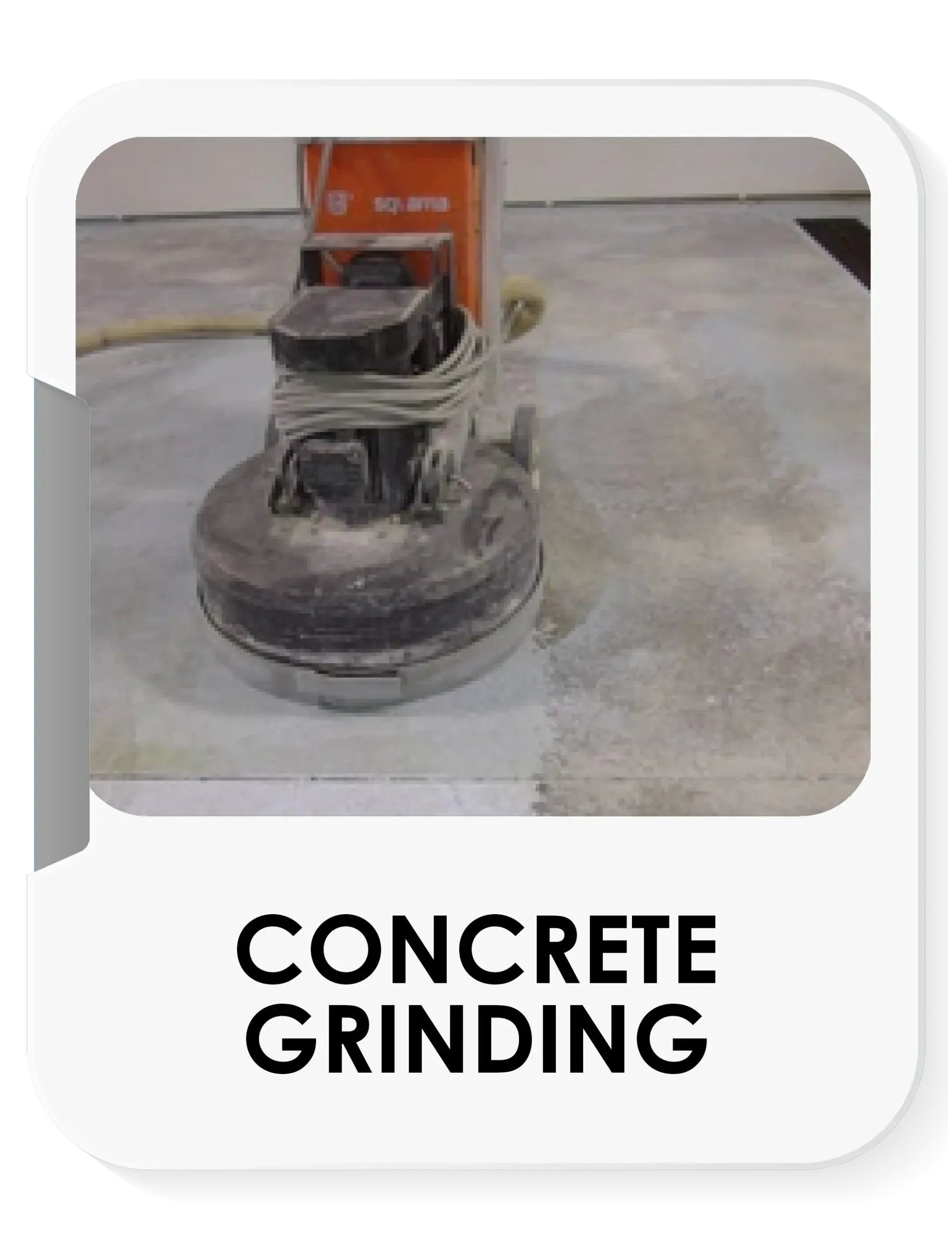 A concrete grinder is being used on a concrete floor.