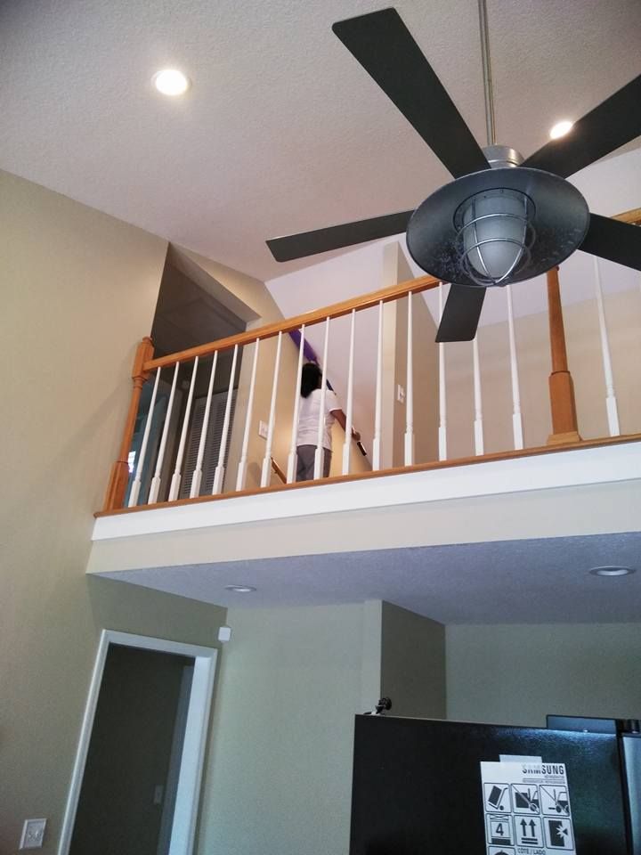 A ceiling fan is hanging from the ceiling above a balcony