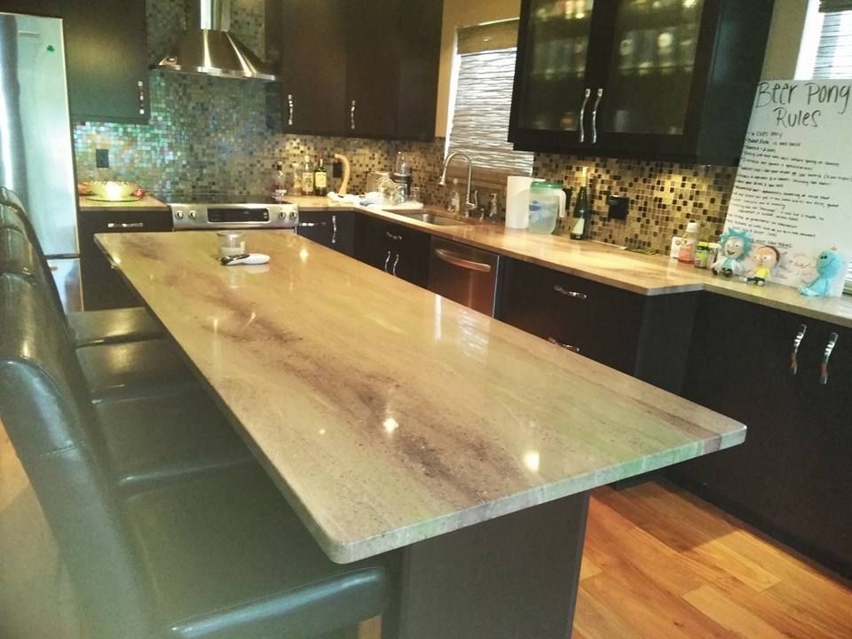 A kitchen with a large island in the middle