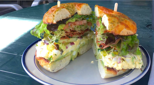 A sandwich on a plate that has been cut in half