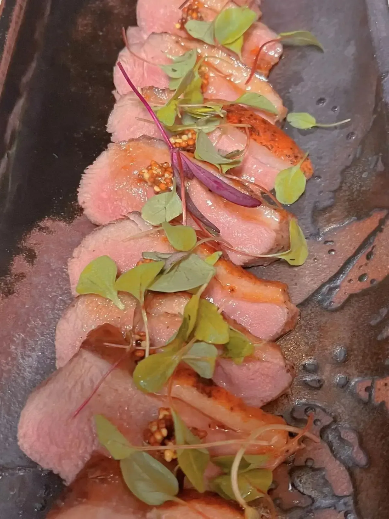 A close up of a plate of food with meat and vegetables