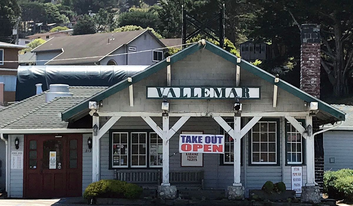 A building with a sign that says take out open