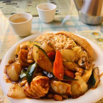 A plate of food with rice and vegetables on a table