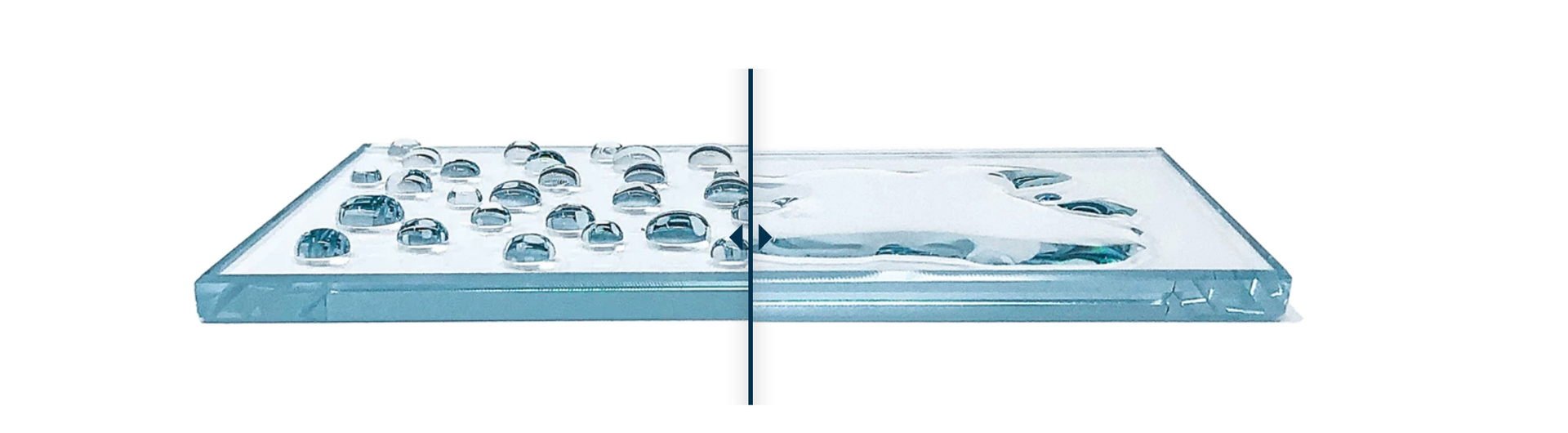 A close up of a piece of glass with water drops on it.