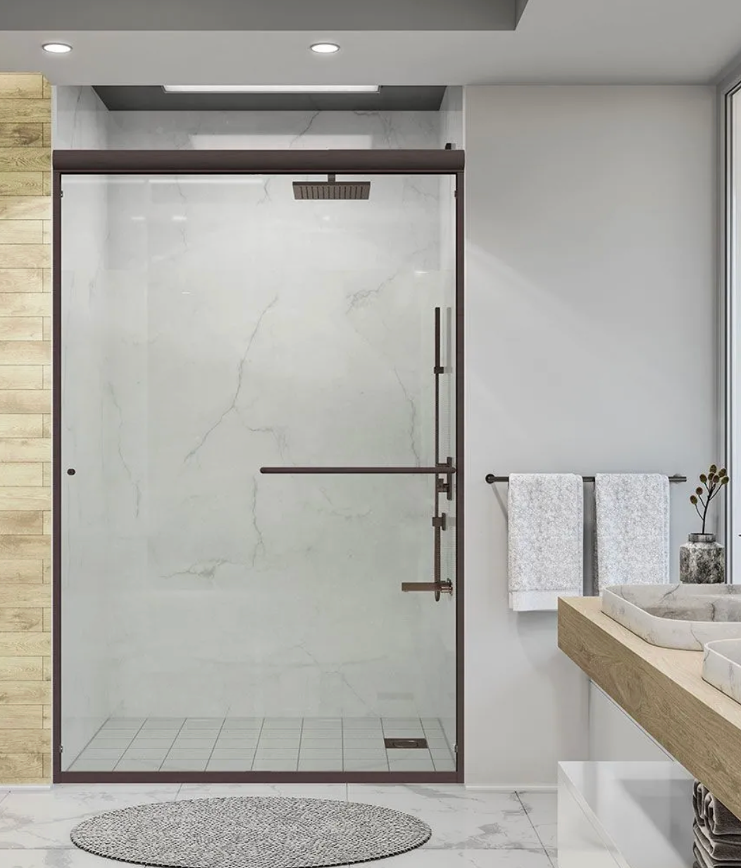 Bathroom with glass shower, brown frame, white towels, and wooden vanity.