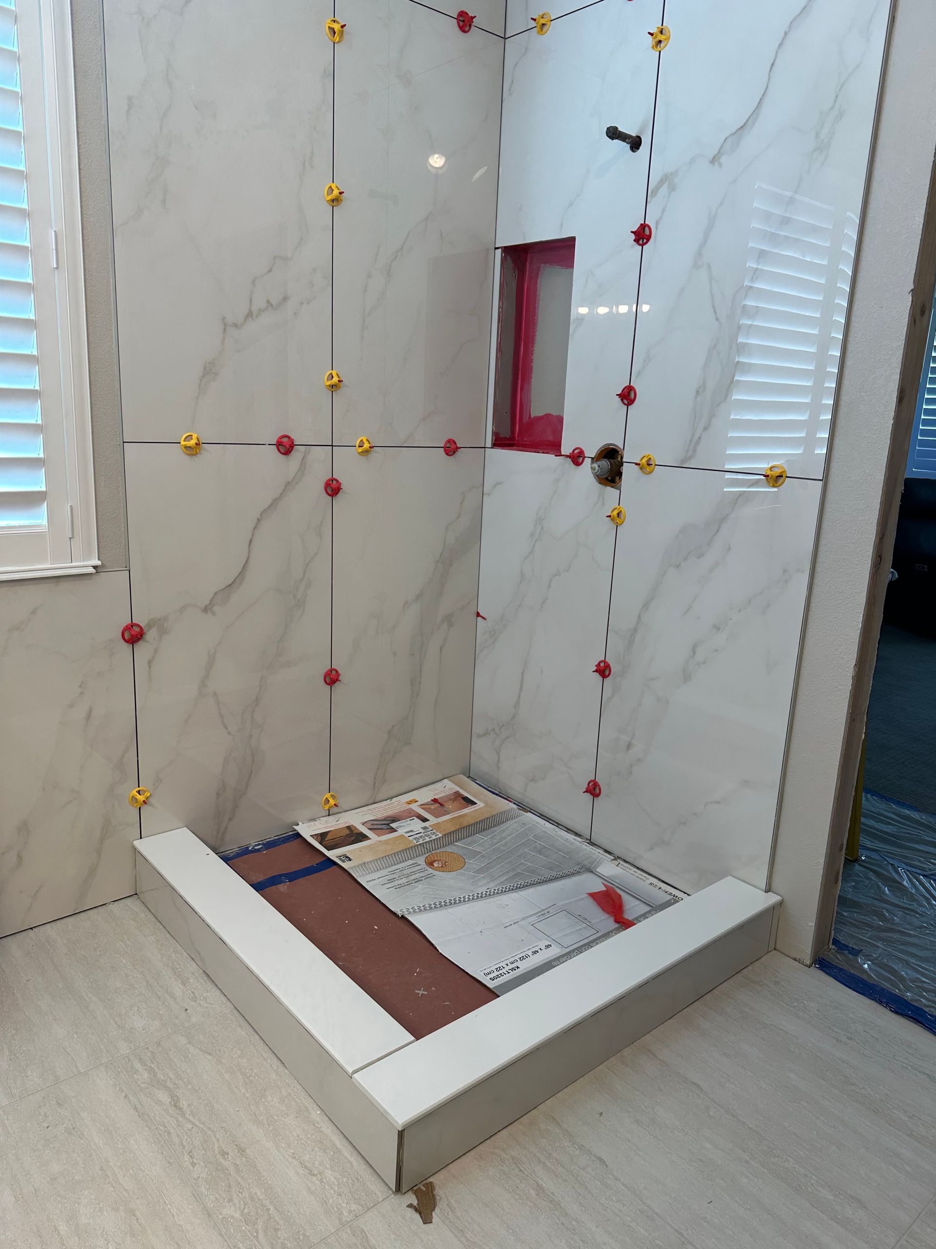 A shower stall is being built in a bathroom.