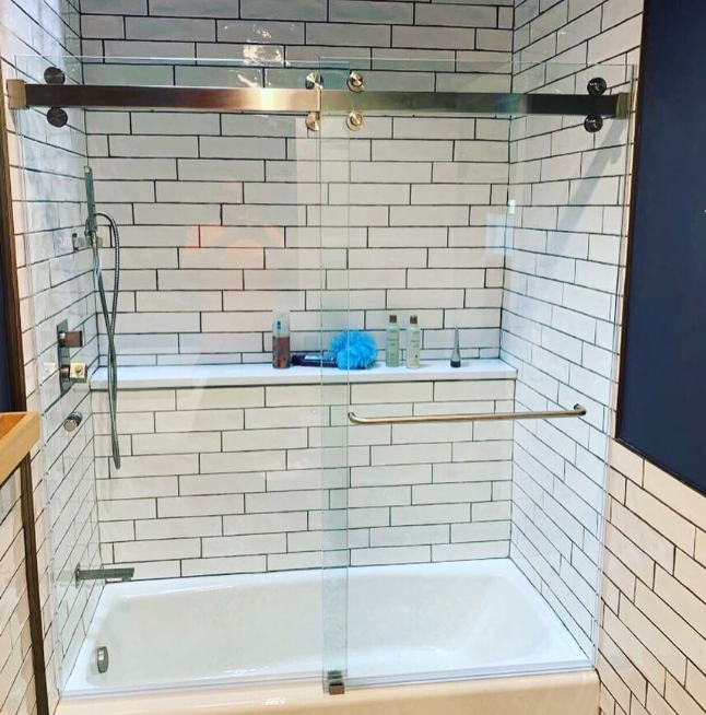 A bathroom with white brick walls and a bathtub