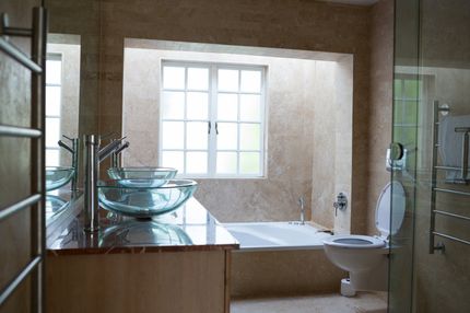 bathroom with toilet and glass sink