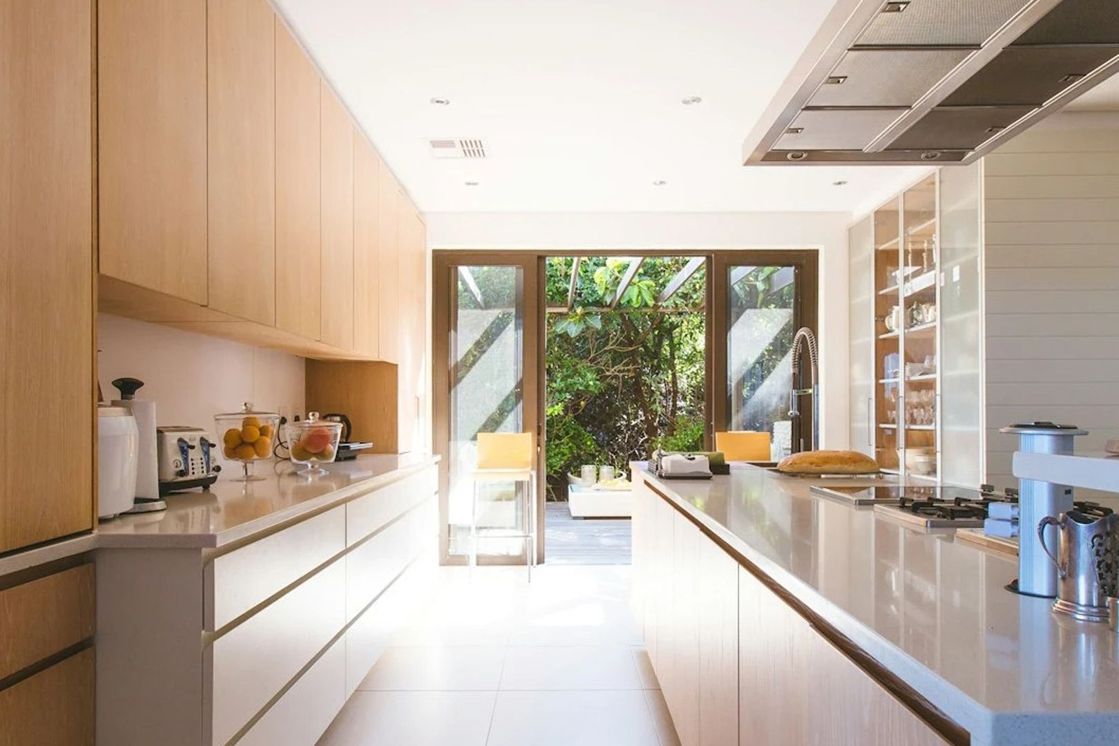 A kitchen with white cabinets and a large island in the middle