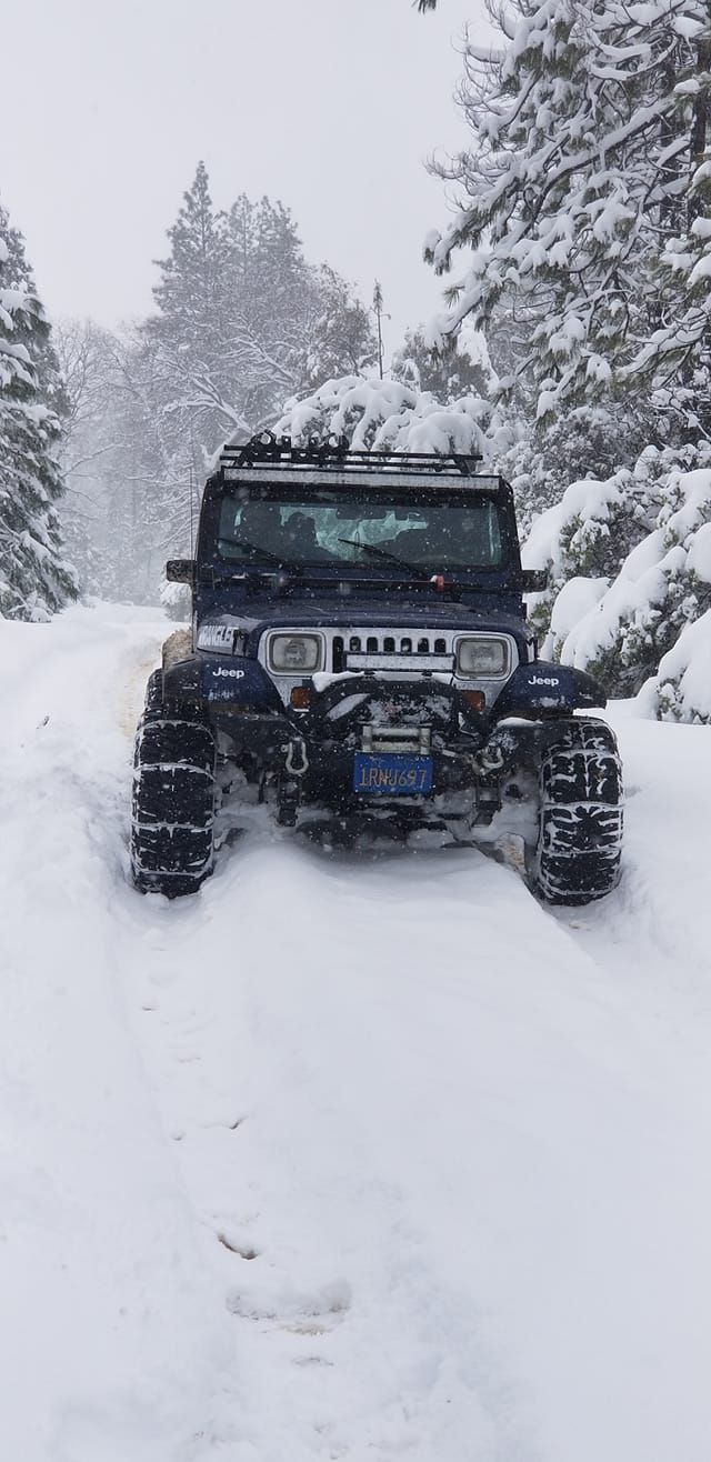 A jeep on a snow road.