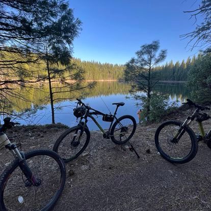 Exterior view of a lake near by the Italian Bar Cabin with three bicycles.