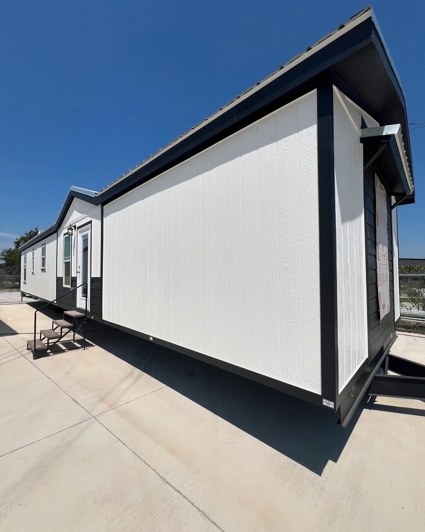 A small house with a lot of windows and stairs.