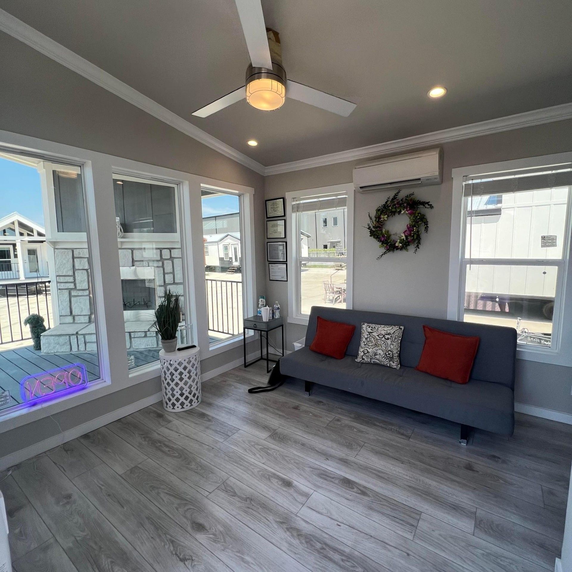 A living room with a couch and a ceiling fan.