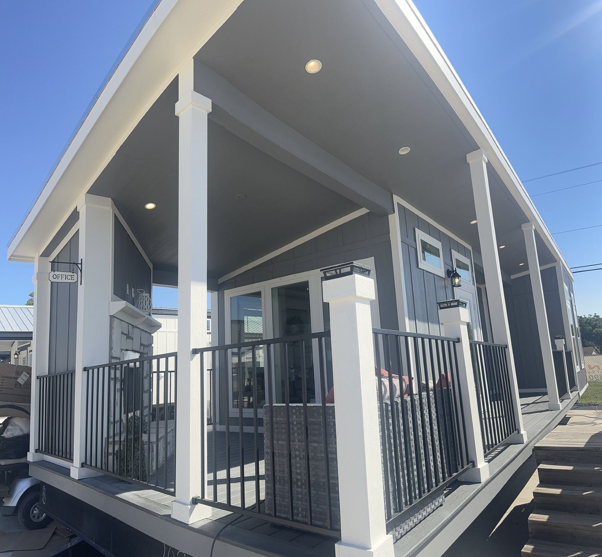 A mobile home with a porch and stairs.