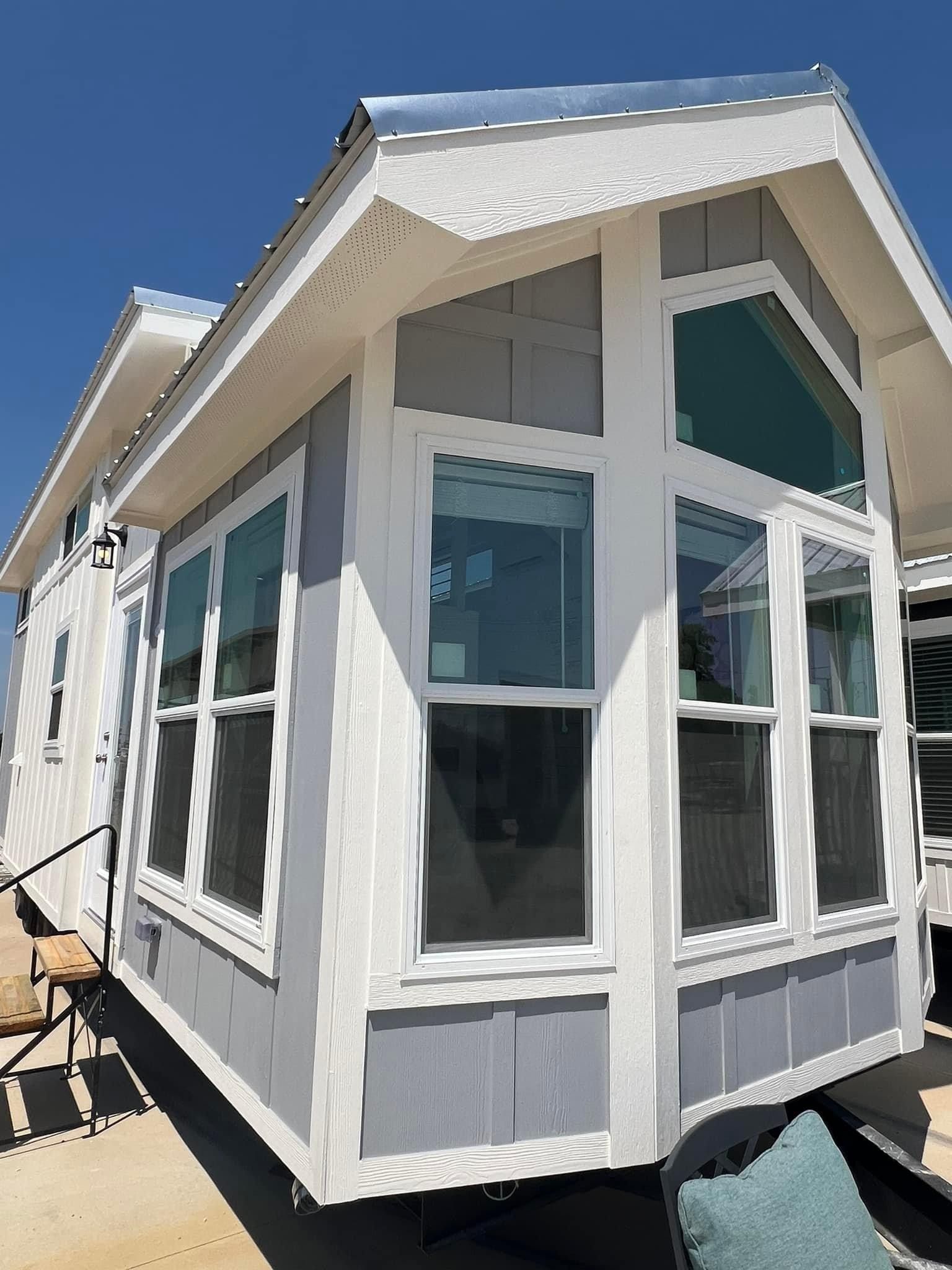 A small house with a lot of windows and stairs.