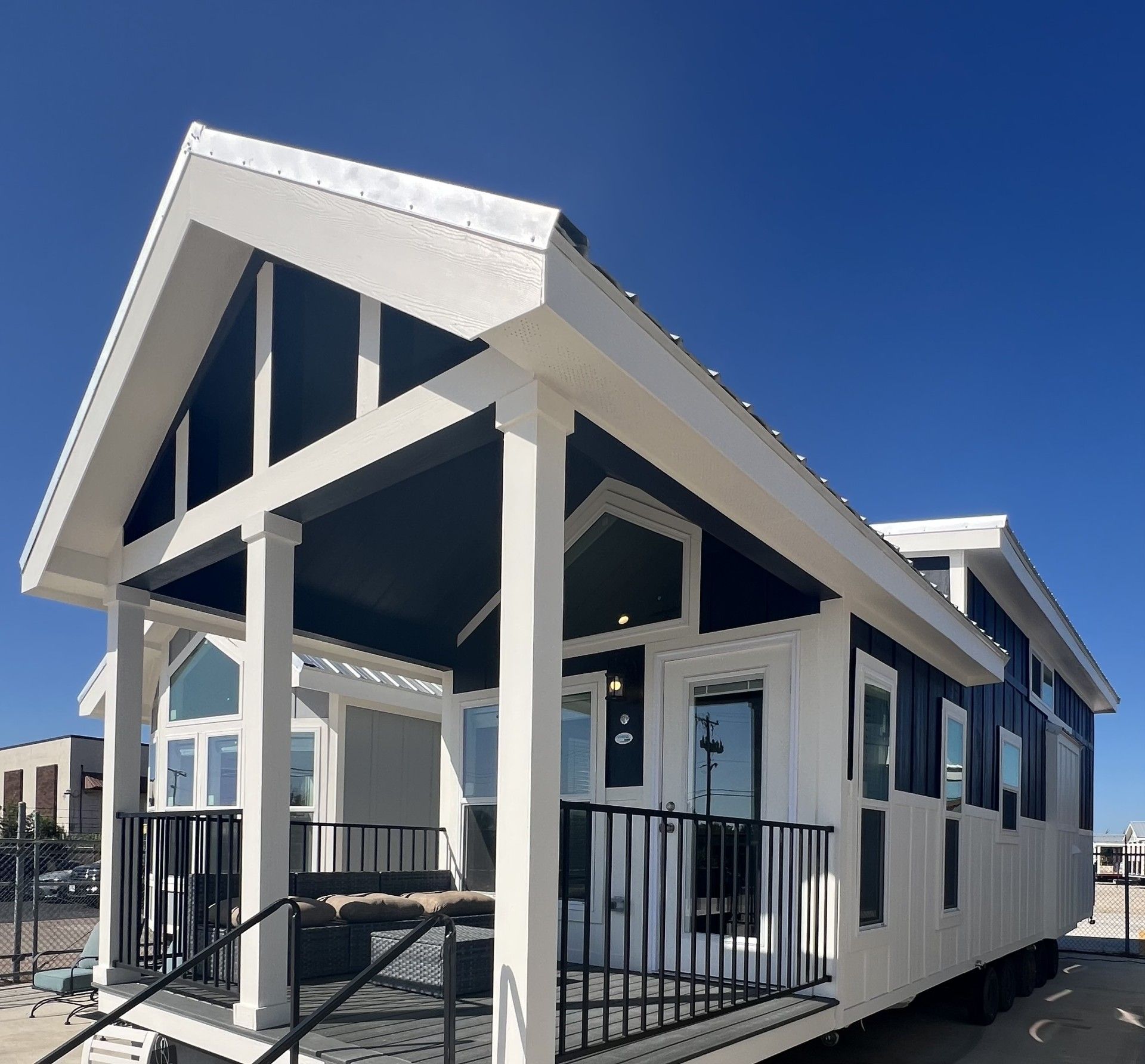 A mobile home with a large porch and stairs