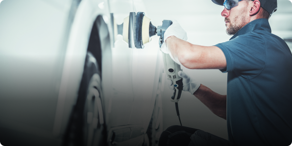 A man is polishing a car door with a machine. | Morrison Corp Mobile Body & Paint