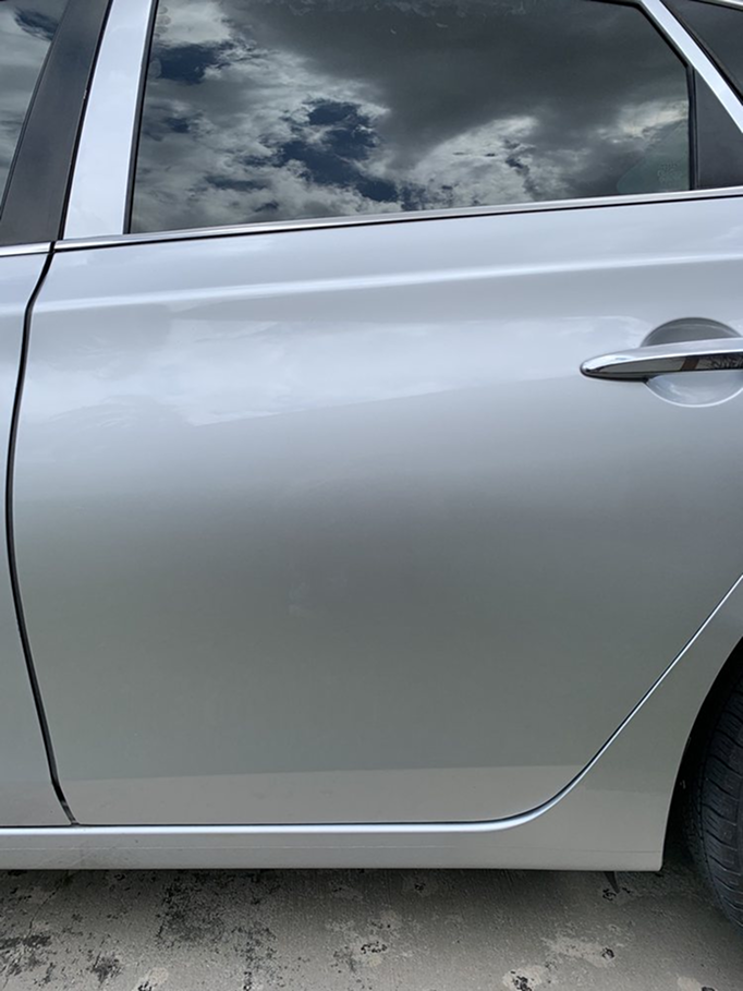 A silver car is parked on the side of the road. | Morrison Corp Mobile Body & Paint