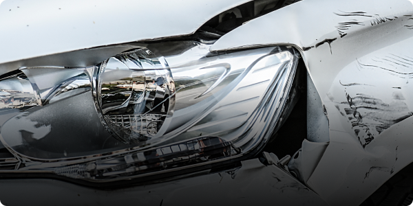 A close up of a car with a damaged bumper and headlight. | Morrison Corp Mobile Body & Paint