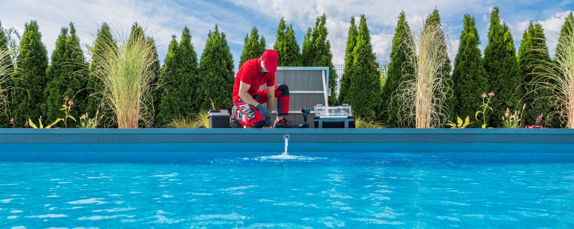 A man is standing on the edge of a swimming pool.