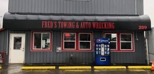 Fred's Towing & Auto Wrecking storefront with a Pepsi vending machine.