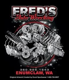 Fred's Auto Wrecking logo featuring a chrome engine assembly on a black background. Includes phone number and city.