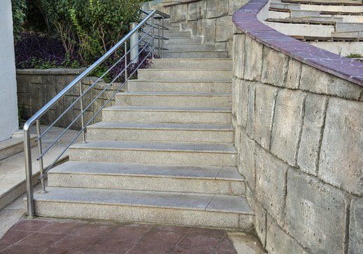 Picture of stone steps with one sided stainless steel handrail and horizontal balustrade