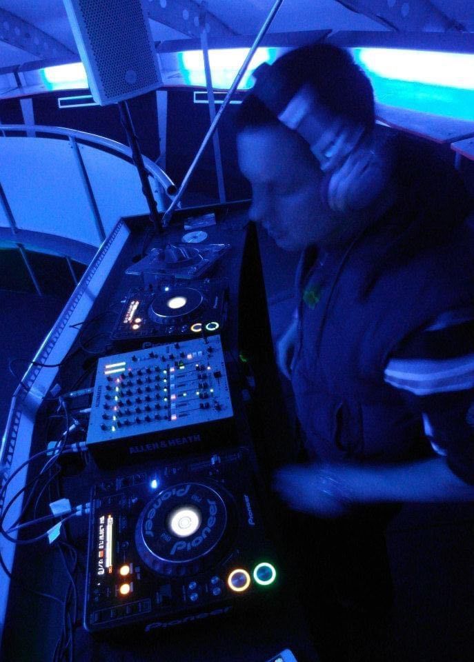 A man wearing headphones is playing a dj set