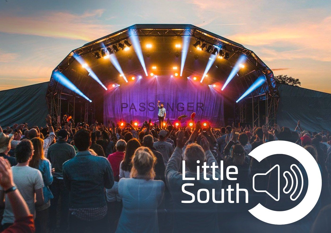 A crowd of people watching a concert at little south