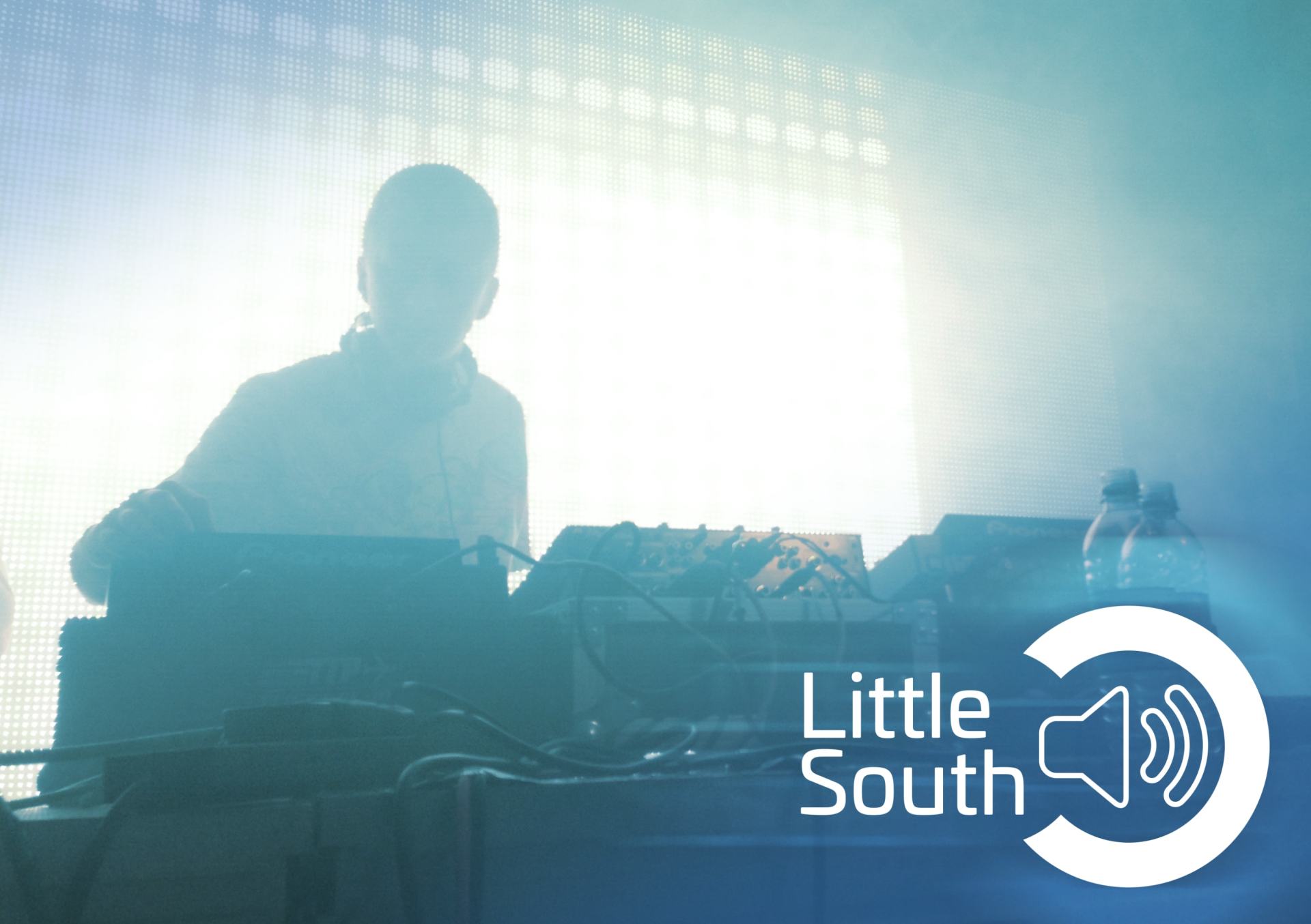 A dj is playing music in front of a little south logo