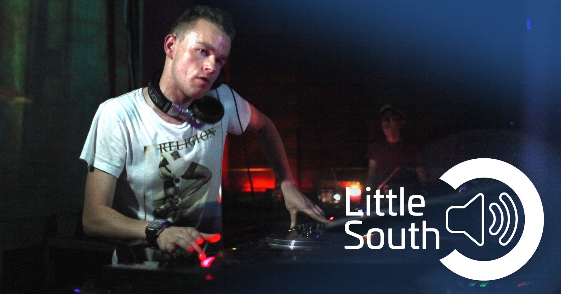 A man is playing music in a little south logo