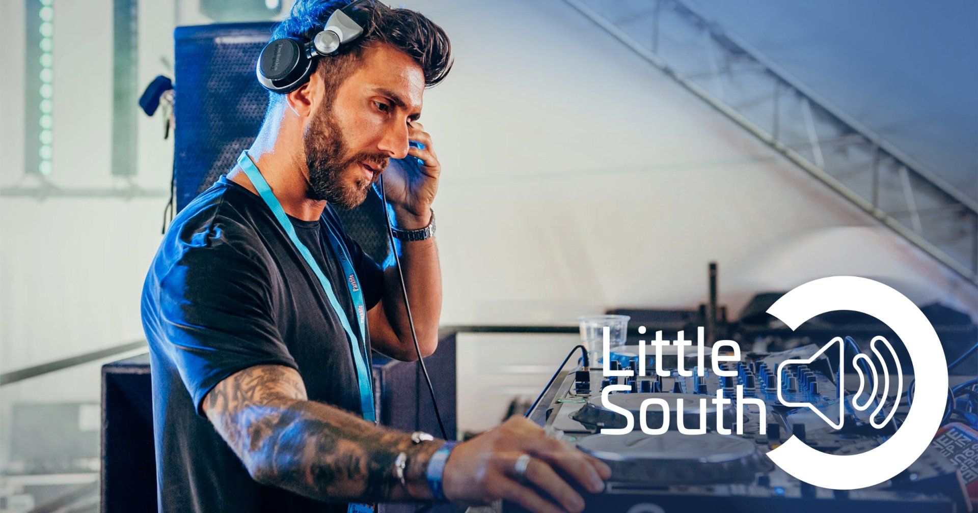 A man wearing headphones is playing music on a turntable.