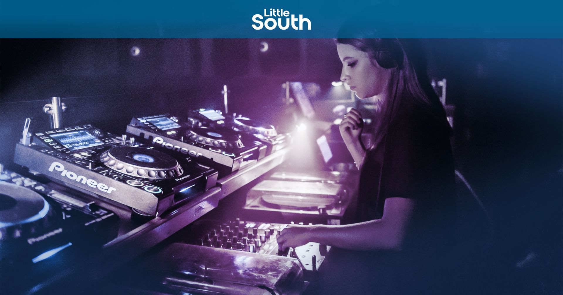 A woman is playing a dj set in a dark room.