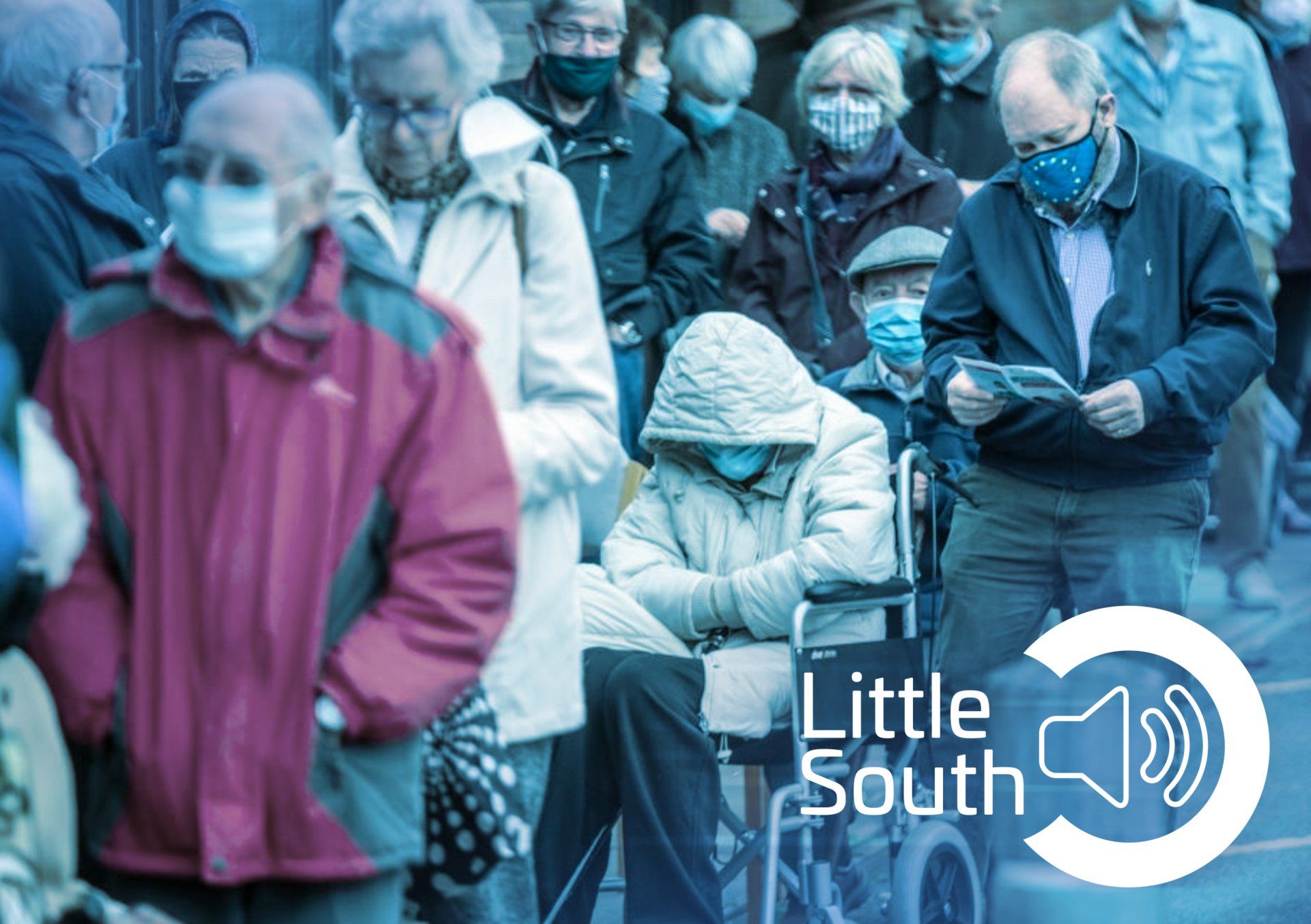 A group of people wearing face masks are standing in a line.