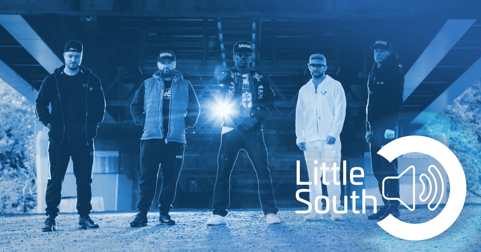 A group of men standing under a bridge with the words little south on the bottom