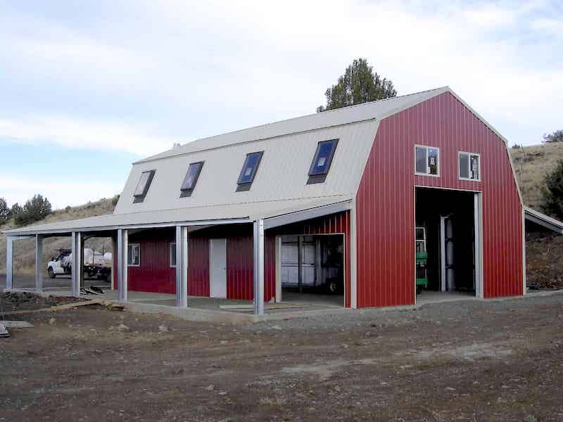 A large red barn with a white roof and windows