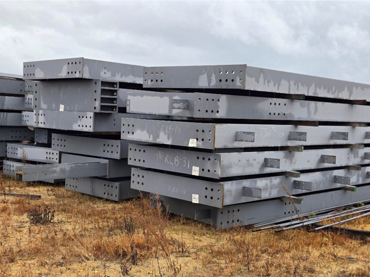 A stack of metal plates sitting on top of each other in a field.