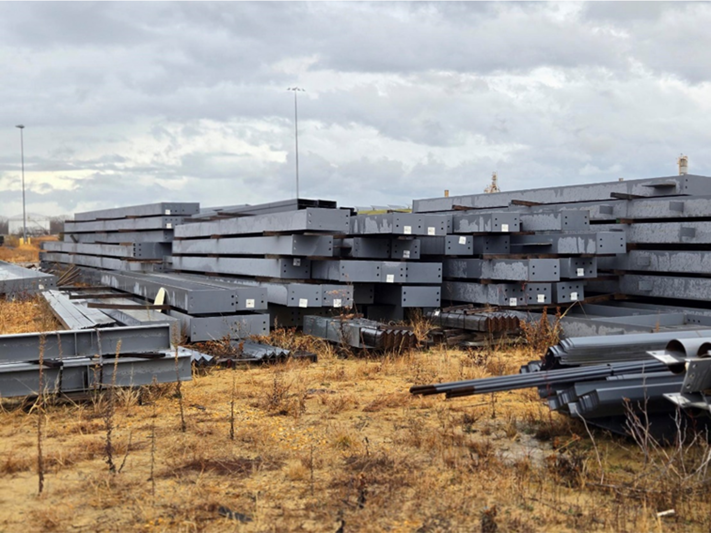 A bunch of metal pieces are stacked on top of each other in a field.