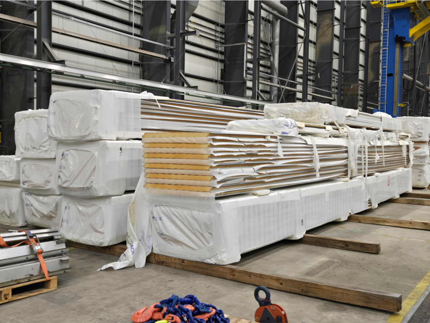 A warehouse filled with lots of boxes wrapped in plastic