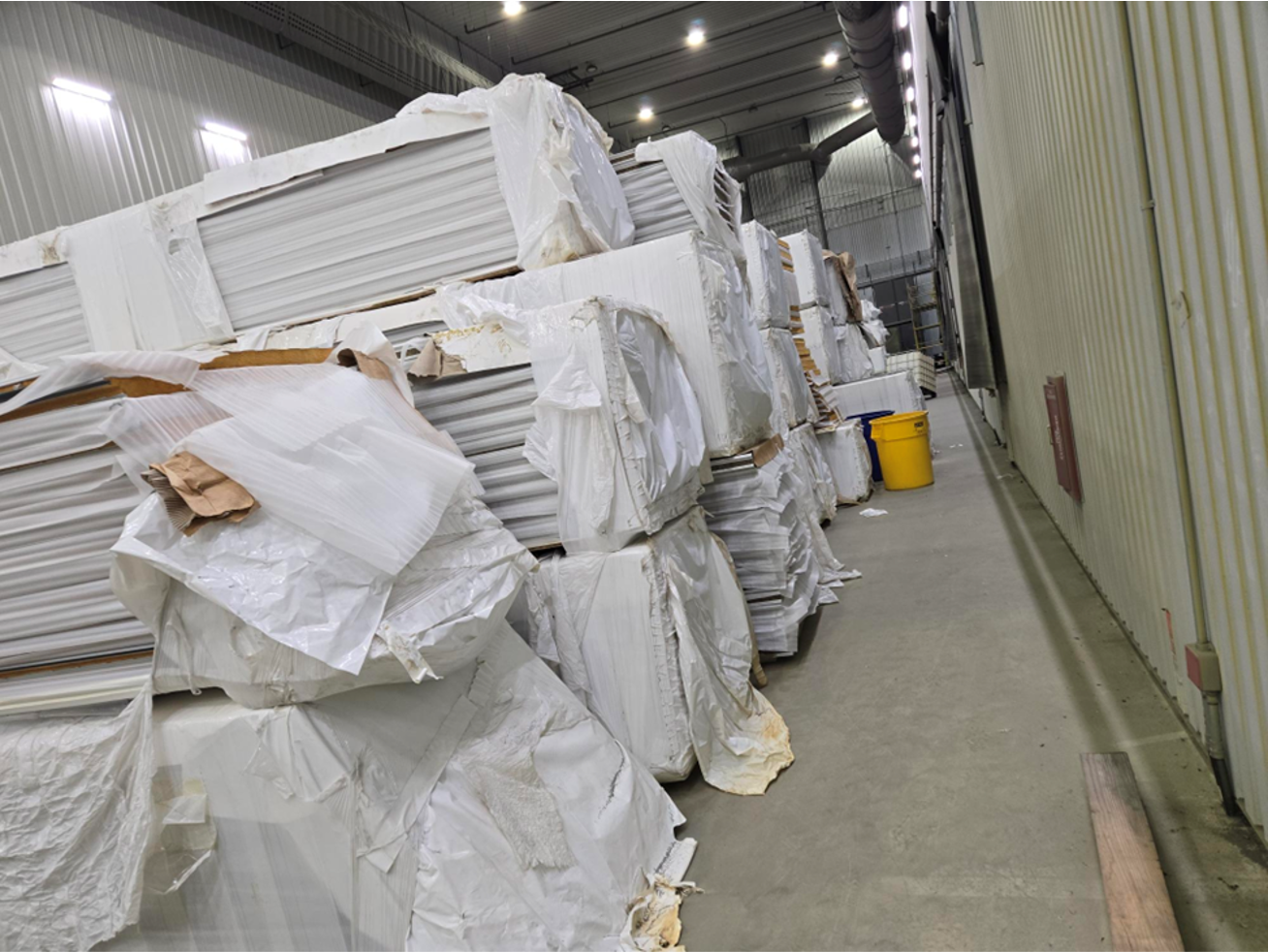 A warehouse filled with lots of boxes and bags.
