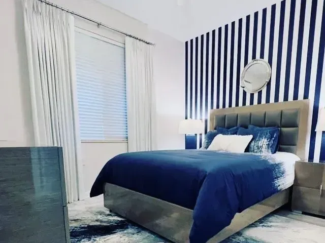 Bedroom with Blue Stripes Design — Naples, FL — Prestige Windows & Décor 