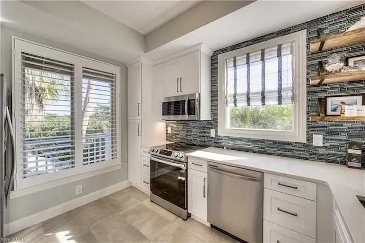 Kitchen Area with Shutters and Blinds for Windows — Naples, FL — Prestige Windows & Décor 